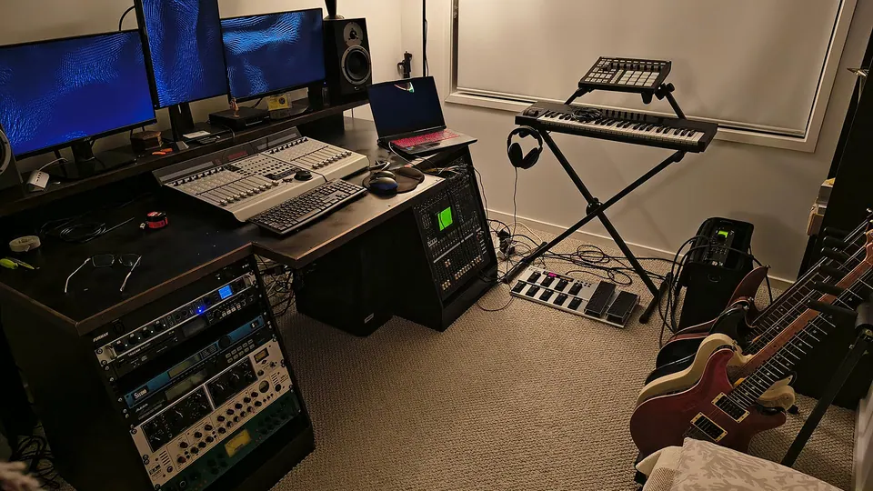 The recording studio: monitors, outboard racks, a keyboard and guitars